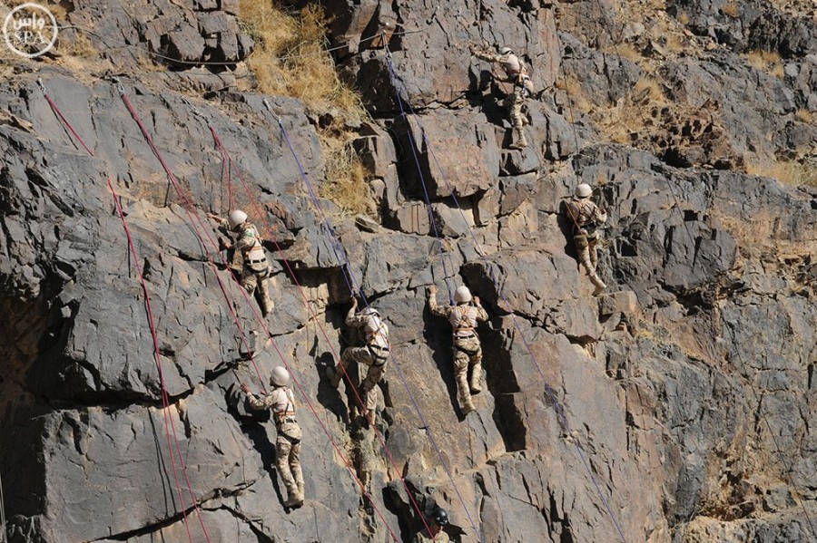 Saudi Military personnel train in rock climbing and fighting into caves. 